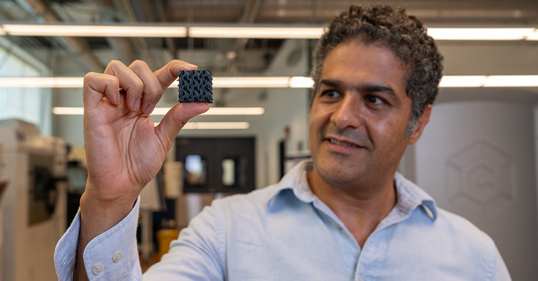 Ali Khosravi, assistant professor of civil and environmental engineering, examines a 3D-printed lattice structure similar to those his research team will test as part of an adaptive foundation system for expansive soils.