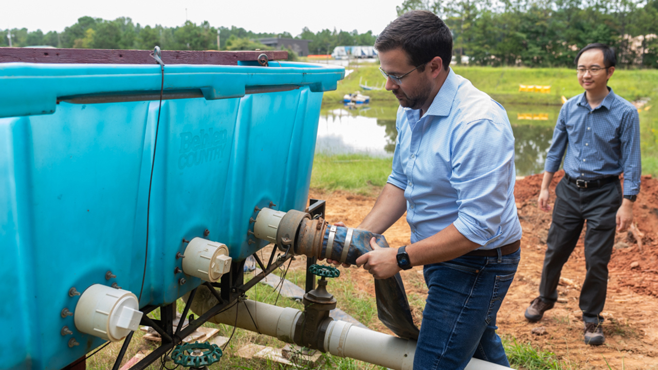 man connects hose to machine