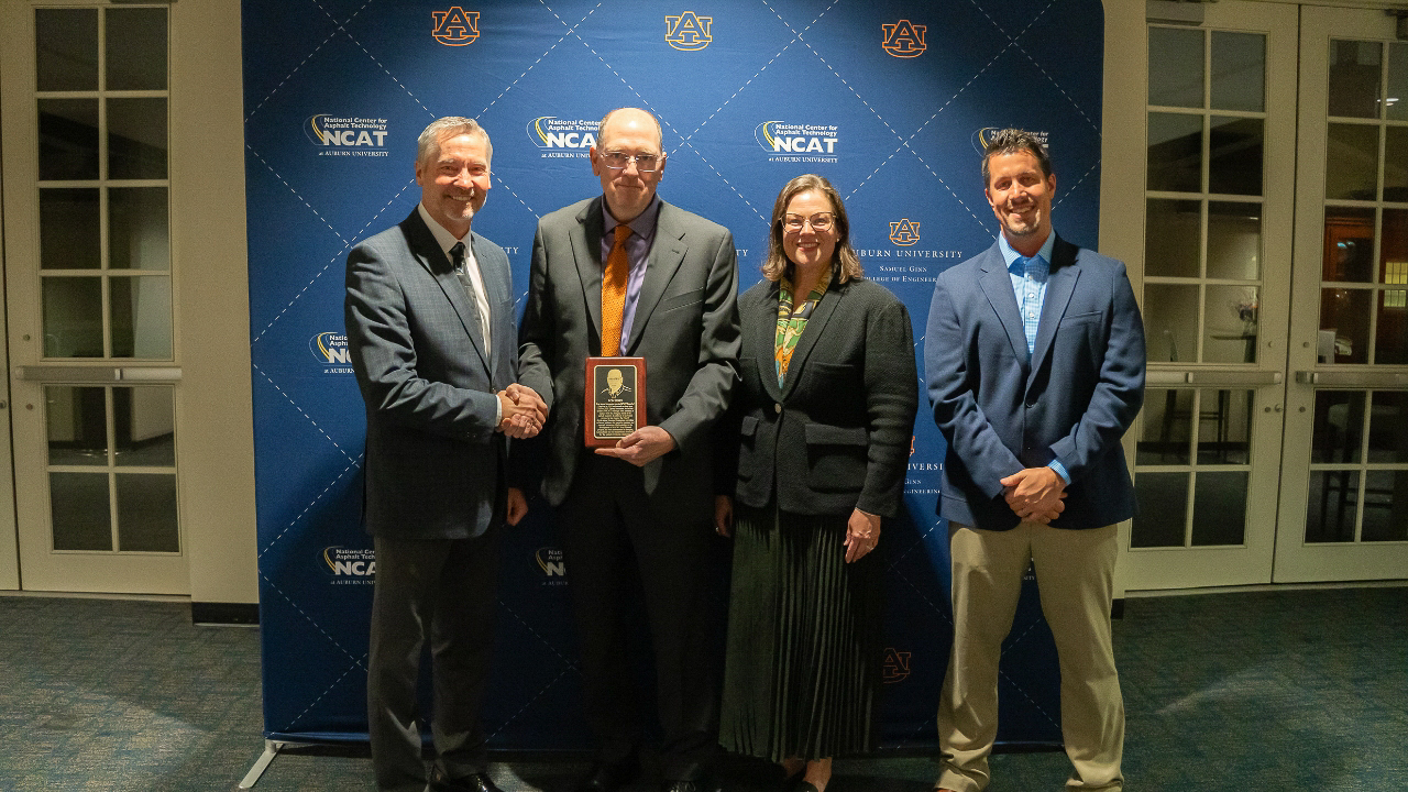 Ron Sines presented with a commemorative plaque for his induction onto the NCAT Wall of Honor. Pictured, from left: Randy West, Ron Sines, Audrey Copeland, Brian Enders.