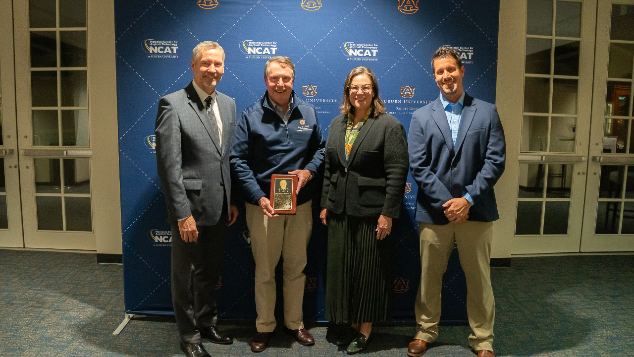 Jay Winford presented with a commemorative plaque for his induction onto the NCAT Wall of Honor. Pictured, from left: Randy West, Jay Winford, Audrey Copeland, Brian Enders.